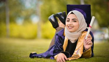 Graduate Holding A Diploma