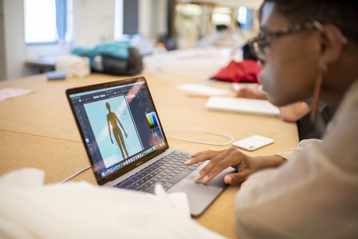 UNT fashion design student works on a design on her laptop. 