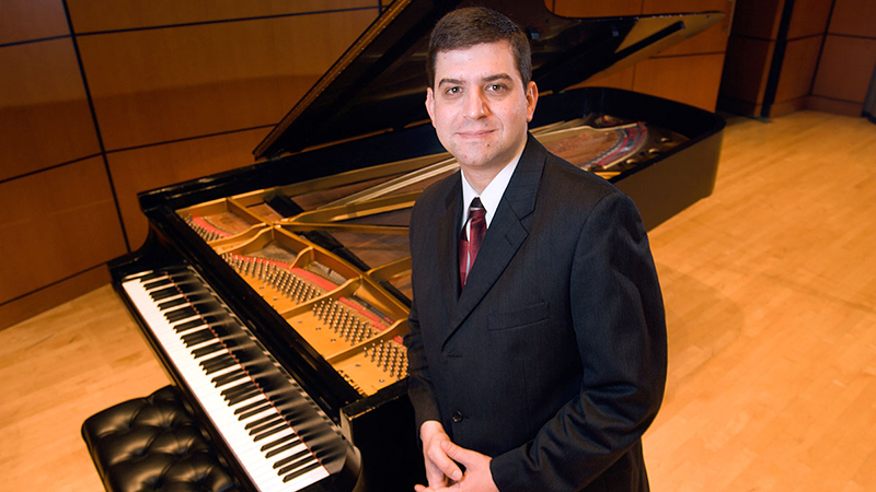 Peter Jutras publicity shot sitting at piano