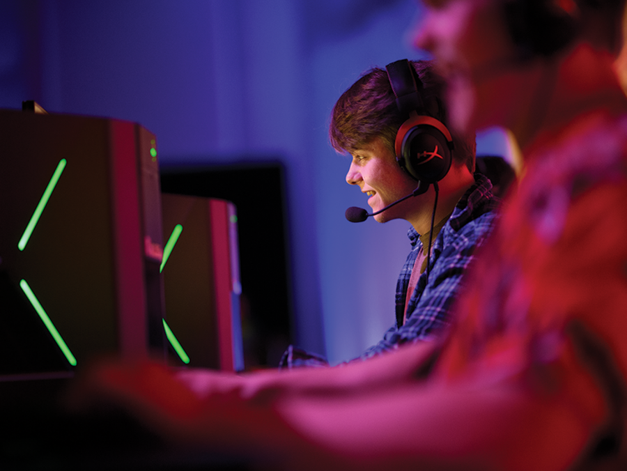 Student at a computer wearing a headset with microphone