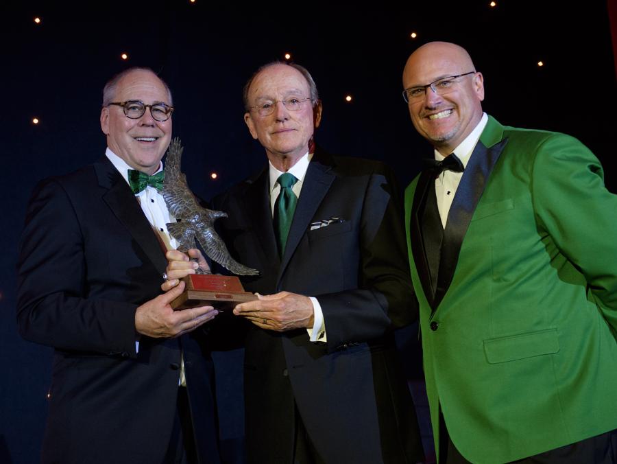 <p>President Neal Smatresk and Vice President for Advancement David Wolf present the Wings of Eagles Presidential Award to Jim McNatt ('66).</p>
