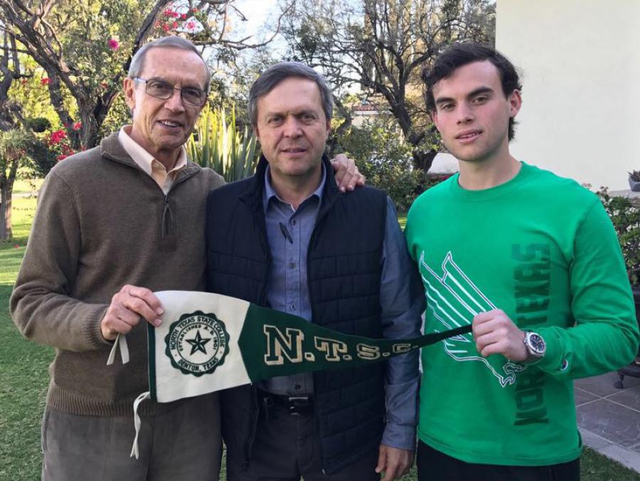 Ernesto G., Jorge Ernesto and Ernesto B. Usabiaga hold a NTSC pennant