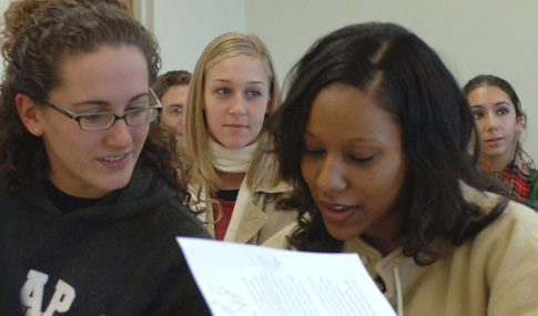 Students study notes in an honors college class.