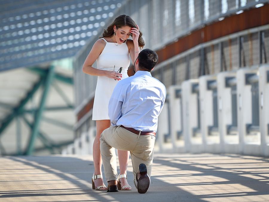 Chris Lee proposes to Karen Alday at the UNT pedestrian bridge.