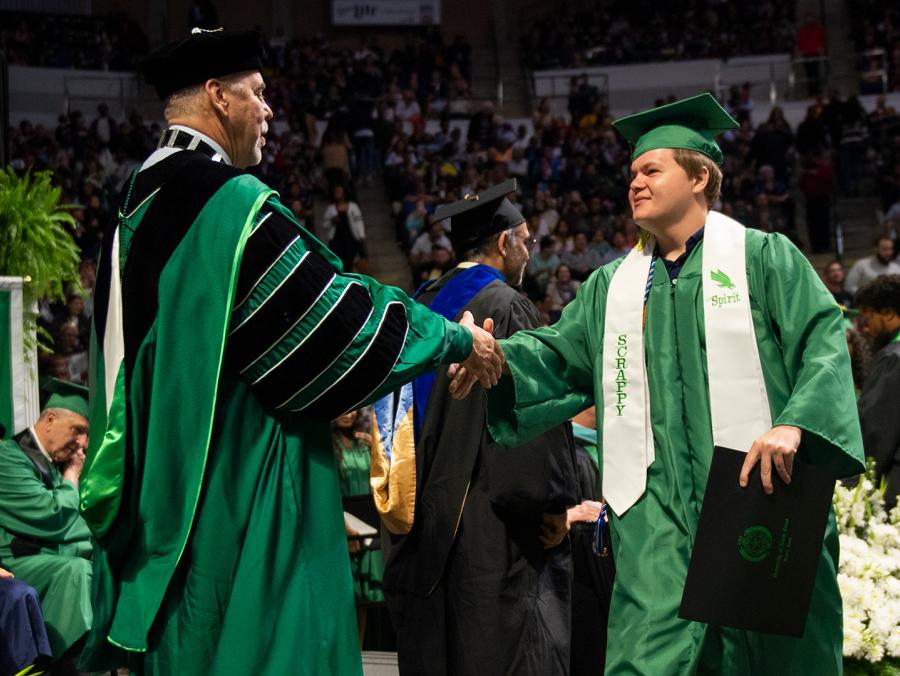 Mac Neuroth who also performed as the UNT mascot Scrappy participates in commencment