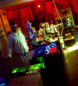 Sputter initiated resonance ion spectroscopy (SIRIS) The ionization laser is in 
									the foreground and the ion accelerator is in the background right
