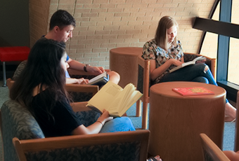 people sitting in casual seating area reading