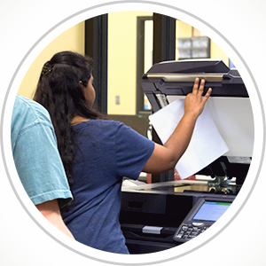 four people standing at a print release station