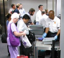 Air travelers at a TSA security screening checkpoint.