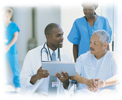 Photograph of a doctor talking to a patient in a hospital.