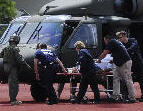 Disaster Medical Assistance Team, with help from US Army Blackhawk crew, unloads patient at medical special needs shelter in Louisiana