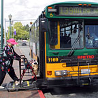 Photo: woman uses lift to board bus