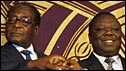 Robert Mugabe (l) and Morgan Tsvangirai (r) after signing a power-sharing deal in Harare, 15 September 2008