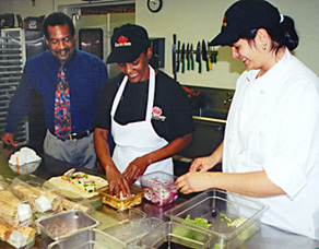 Photo: Clients prepare vegetables for the salad bar at Earthfare.