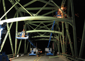 ODOT crews work on a bridge at night.