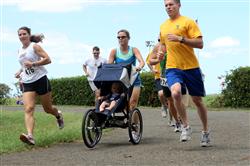 Daly Lynne squeezes her way through the traffic of runners during the 12th Annual 5K Grueler Sept. 17.  
