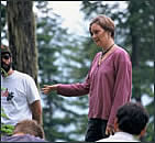 [Photograph: Student conducts an outdoor seminar to forest managers and researchers.