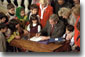 Surrounded by children, President George W. Bush signs the Afghan Women and Children Relief Act of 2001 at The National Women's Museum in the Arts Dec. 12, 2001. "The overwhelming support for this legislation sends a clear message: As we drive out the Taliban and the terrorists, we are determined to lift up the people of Afghanistan," said the President in his remarks. White House photo by Tina Hager.