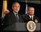 President George W. Bush answers questions from reporters following his meeting on Iraq with U.S military leaders at the Pentagon, Wednesday, Dec. 13, 2006. Admiral Edmund P. Giambastiani is seen at right.  White House photo by Eric Draper