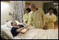 President George W. Bush awards the Purple Heart to U.S. Marine Corps Cpl. Edgardo Velazquez of Bronx, N.Y., at the National Naval Medical Center in Bethesda, Md., Tuesday, Aug. 1, 2006. Also pictured are his wife, Loureann, left, and nurse, Roselin Imarti. White House photo by Eric Draper