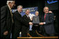 President George W. Bush holds the box containing the energy bill after signing the H.R. 6, The Energy Policy Act of 2005 at Sandia National Laboratory in Albuquerque, New Mexico, Monday, Aug. 8, 2005. Also on stage from left are Congressman Ralph Hall (R, TX), Congressman Joe Barton (R, TX), Senator Pete Domenici (R, NM) and Senator Jeff Bingaman (D, NM).  White House photo by Eric Draper