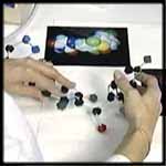 Researcher building model of a molecule.