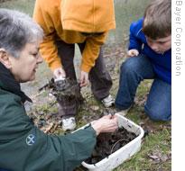 Bayer scientist Pat Jacobs conducts experiments with local middle school students on the Bayer campus in Pittsburgh, a portion of which is used as wildlife habitat education center. 