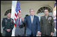 President George W. Bush addresses the media Wednesday, Oct. 5, 2005, in the Rose Garden, flanked by Gen. David Petraeus, former Commander of the Multinational Security and Transition Team in Iraq; Secretary of Defense Donald Rumsfeld, and Gen. Peter Pace, Chairman of the Joint Chiefs of Staff. White House photo by Paul Morse