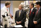 President George W. Bush listens to Dr. Marston Linehan, left, chief of Urological Oncology, as he tours a cancer lab at the National Institutes of Health in Bethesda, Md., Wednesday, Jan. 17, 2007. Also pictured are Health and Human Services Secretary Mike Leavitt, right, and NIH Director Dr. Elias Zerhouni, far right. White House photo by Eric Draper