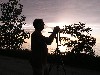 Silhouette of Man next to camera tripod