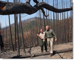 President George W. Bush tours the Squires Peak Fire Area in Medford, Ore., with Ron Wenker of the Medford Bureau of Land Management Properties District, Thursday, Aug. 22, 2002. White House photo by Eric Draper.