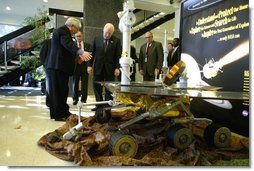 Vice President Dick Cheney looks at a replica of NASA's rover Spirit while touring the Jet Propulsion Laboratory in Pasadena, Calif., Jan. 14, 2004. Spirit, developed and controlled at the laboratory, will explore Mars' Gusev Crater to determine whether the planet ever contained water and if it could sustain life.  White House photo by David Bohrer