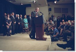 Accompanied by Congress members, President George W. Bush signs the Farm Security and Rural Investment Act of 2002 in the Dwight D. Eisenhowser Executive Office Building May 13. "This bill is generous, and will provide a safety net for farmers. And it will do so without encouraging overproduction and depressing prices. It will allow farmers and ranchers to plan and operate based on market realities, not government dictates," said the President. White House photo by Eric Draper.