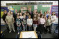 President George W. Bush is joined by Indiana Gov. Mitch Daniels, center, and Indiana Congressman Baron Hill, at left, as they pose for a photo with students and teachers Teri Sanders and Tammy Persinger in the fifth grade U.S. History class at the Silver Street Elementary School in New Albany, Ind., Friday, March 2, 2007. White House photo by Eric Draper