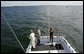 President George W. Bush, left, is seen fishing aboard a fishing boat Saturday, Oct. 20, 2007 off the coast of St. Michaels, Md., in the Chesapeake Bay, for a television interview with Chris and Melissa Fischer, hosts of ESPN’s Offshore Adventures, where President Bush talked about his love of the outdoors and his signing of an Executive Order earlier in the day to protect striped bass and red drum fish species. White House photo by Eric Draper