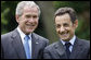 President George W. Bush and French President Nicolas Sarkozy spend a few moments together talking during a sculpture unveiling Saturday, June 14, 2008 at the U.S. Ambassador's residence in Paris. White House photo by Eric Draper