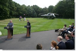 President George W. Bush listens as Afghanistan President Hamid Karzai addresses the media at a joint press availability Monday Aug. 6, 2007, at Camp David near Thurmont, Md., thanking the American people for all that they have done for Afghanistan. White House photo by Chris Greenberg