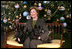 Mrs. Laura Bush sits with Barney and Miss Beazley before the White House Christmas tree, Wednesday, Nov. 30, 2007, in the Blue Room of the White House.