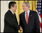 President George W. Bush shakes hands with Kay Hiramine of Colorado Springs, Colo., as he presents Hiramine with the President’s Volunteer Service Award Thursday, May 10, 2007, in the East Room of the White House, in celebration of Asian Pacific American Heritage Month. White House photo by Eric Draper