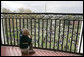 A young guest from the breakfast reception for the 2007 White House Easter Egg Roll peeks through the railing on the Truman Balcony for a birds-eye view of the activities on the South Lawn. White House photo by Shealah Craighead