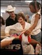 Laura Bush meets with people while visiting a clothing distribution site at the Biloxi Community Center, Tuesday, Sept. 27, 2005 in Biloxi, Miss., where she also interviewed with the television program, ABC's Extreme Makeover: Home Edition. White House photo by Krisanne Johnson