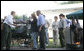 As President George W. Bush and Laura Bush look on, German Chancellor Angela Markel slices up some barbeque Thursday, July 13, 2006, during dinner in Trinwillershagen, Germany. The Bushes continue their Europe trip when they depart Germany Friday en route to Russia and the G8 Summit. White House photo by Shealah Craighead