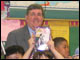 Superintendent Ray Daniels and Eugene Ware students show the books they'll be reading over the summer.