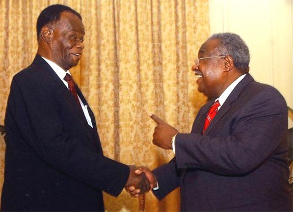 The interim President of Haiti, Boniface Alexandre ,L,, shakes hands with new Prime Minister Gerard Lartotue during the swearing-in ceremony for the premier at the National Palace in Port-au-Prince, H