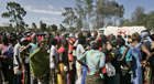 Kenyan residents wait for assistance from the Kenyan Red Cross since being displaced by the elections riots in January 2008.  AP Photo.