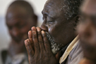 A Kenyan man cries while hearing recounting of riot experiences. AP Photo.