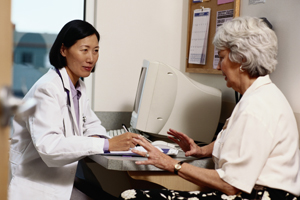 A woman talking to a female doctor