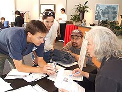 photo of people huddled around a table covered in papers