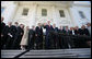 President George W. Bush is surrounded by members of the House Republican Conference on the steps of the North Portico Thursday, March 29, 2007, as he delivers a statement on the budget and the emergency supplemental after meeting with the group. Said the President, "We stand united in saying loud and clear that when we've got a troop in harm's way, we expect that troop to be fully funded; and we've got commanders making tough decisions on the ground, we expect there to be no strings on our commanders; and that we expect the Congress to be wise about how they spend the people's money."  White House photo by Eric Draper