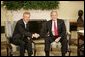 President George W. Bush and Poland's President Aleksander Kwasniewski shake hands as they meet with reporters in the Oval Office at the White House, Wednesday, Oct. 12, 2005 in Washington.  White House photo by Eric Draper